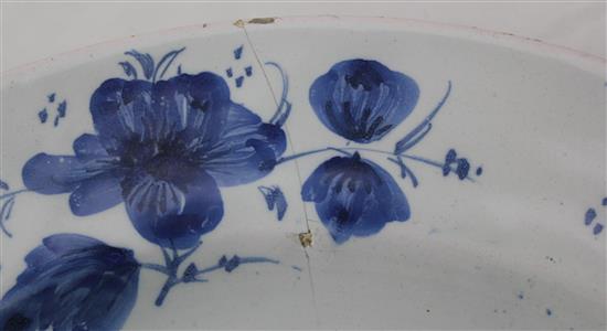 A Glasgow delft ware charger and a similar plate, late 18th century, 35.5cm and 22.5cm, hairline crack to charger